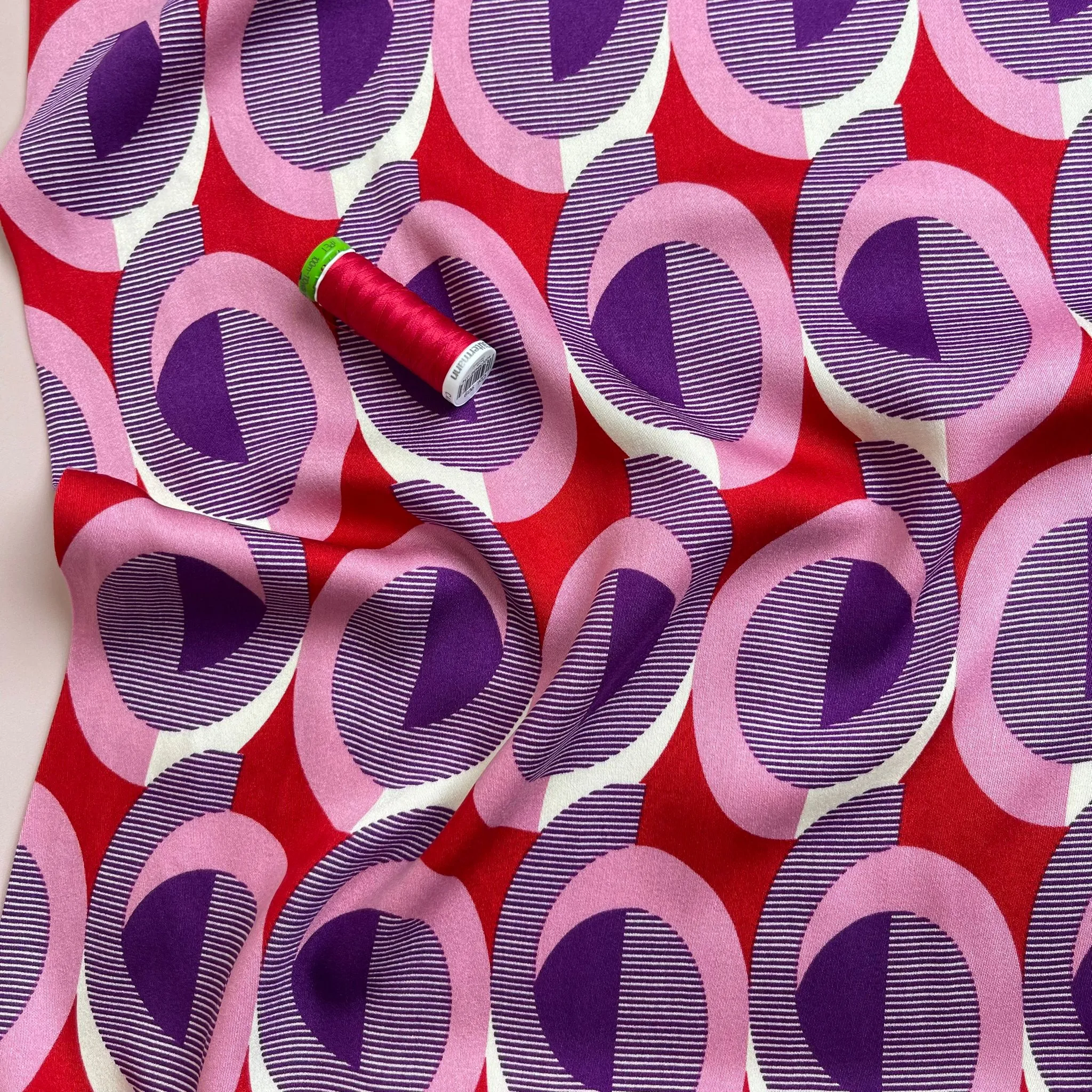 REMNANT 0.55 Metre - Abstract Circles on Red Viscose Twill Sateen Fabric